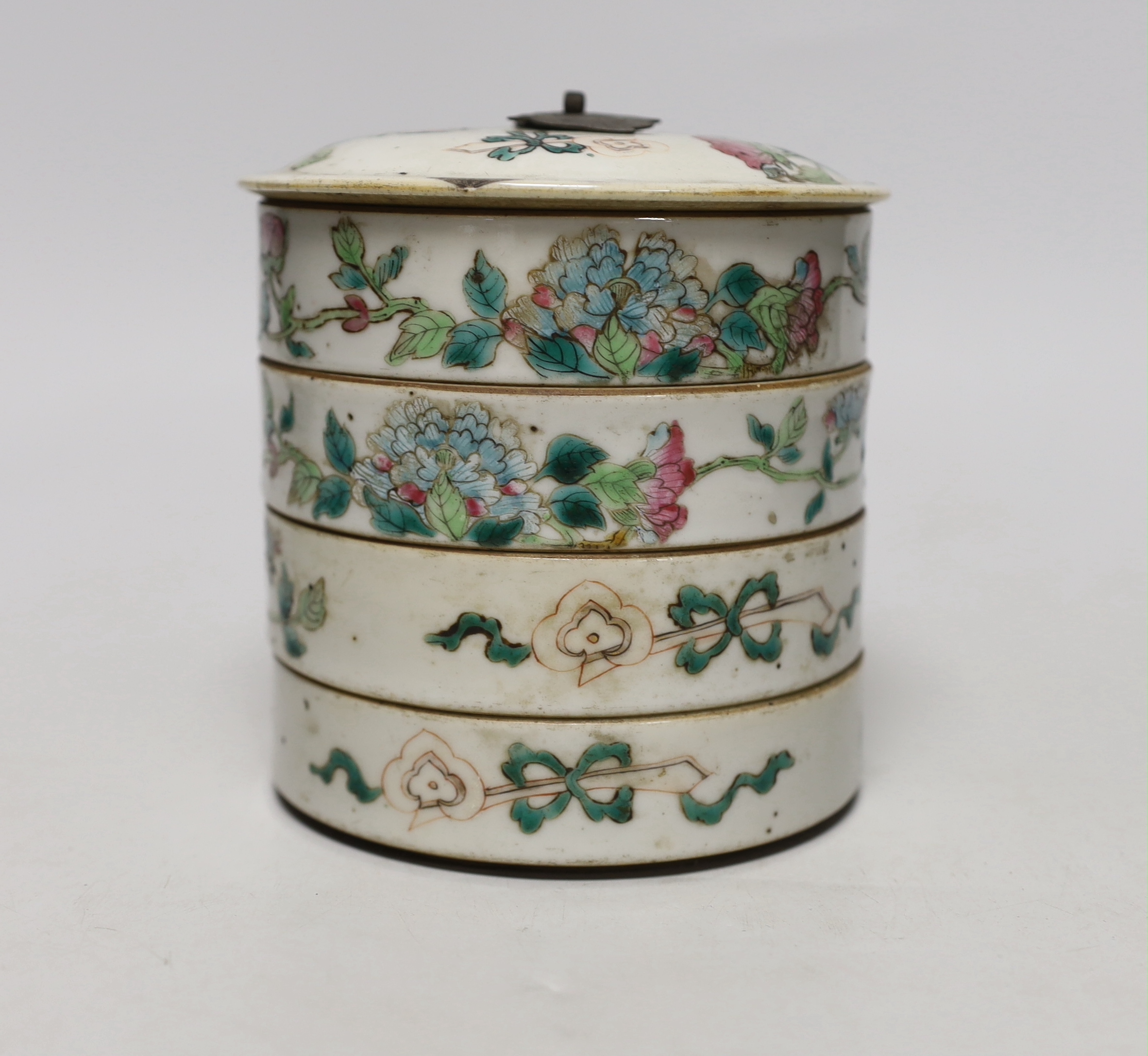 An early 20th century Chinese enamelled porcelain four section stacking food container, with cover 13cm high